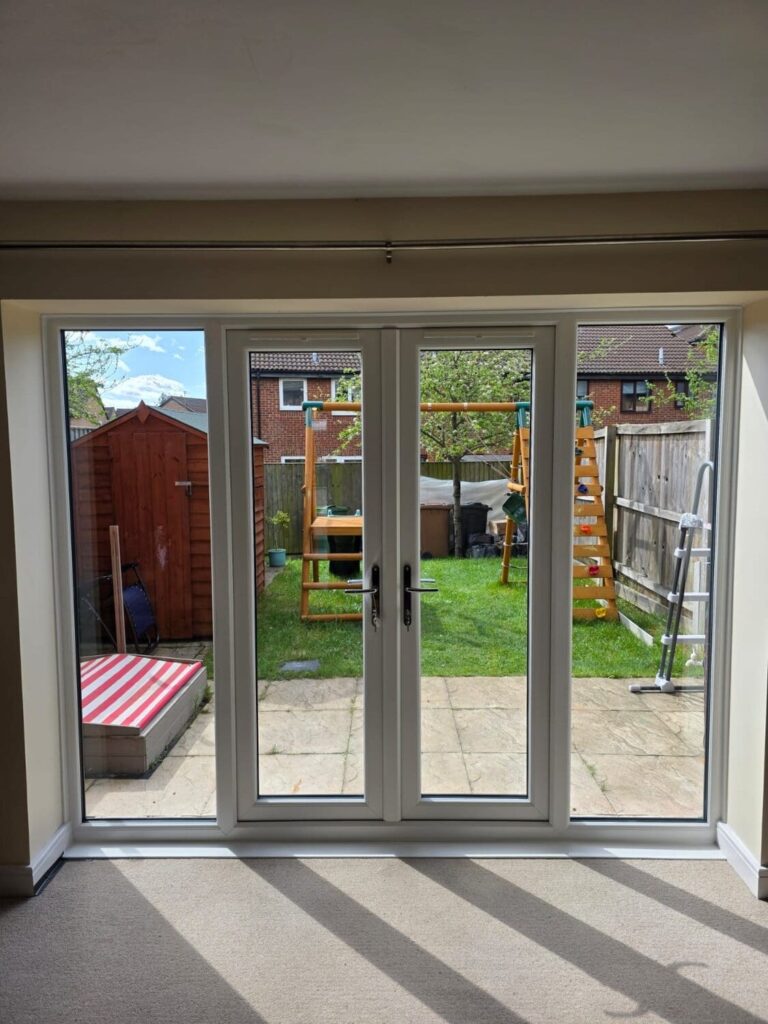 White uPVC French doors opening into the garden