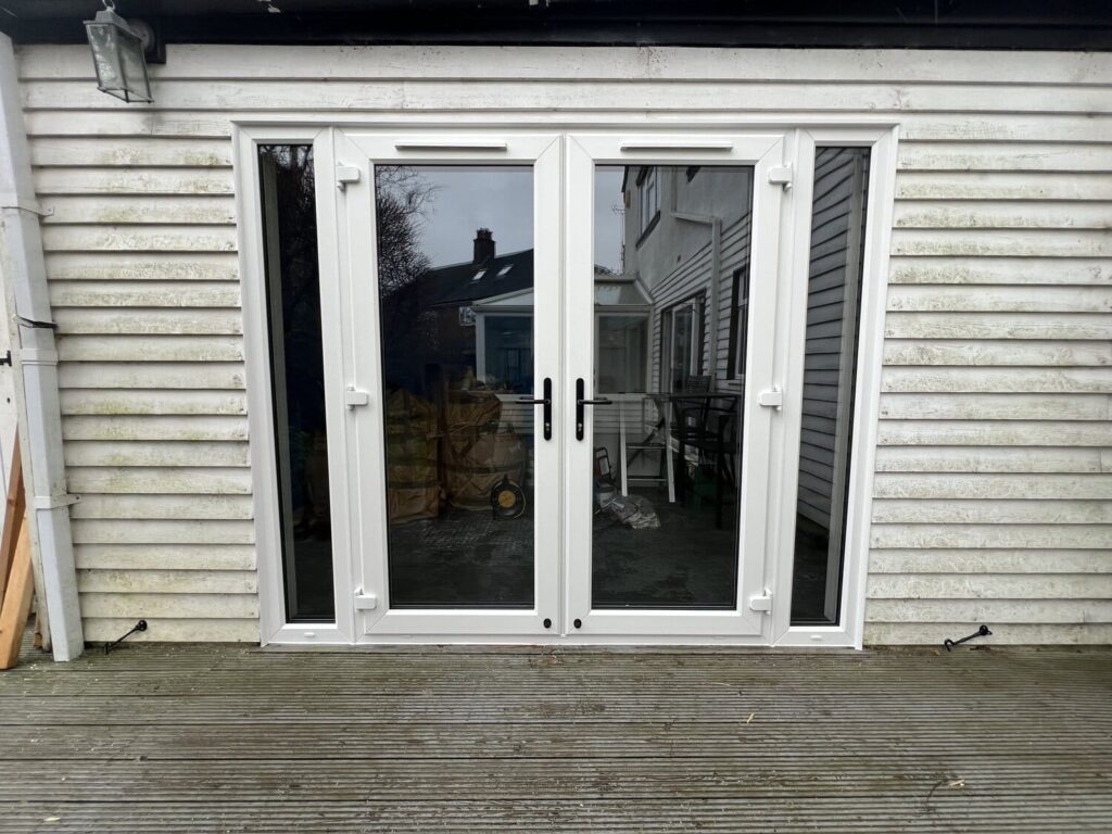 White double glazed patio doors on wooden decking